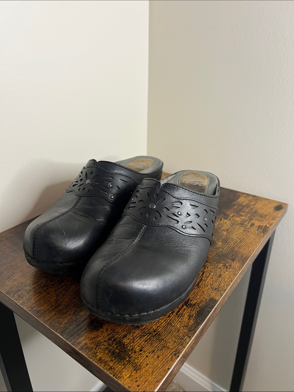 Dansko Shyanne Black Leather Slip-On Clogs with Decorative Perforated Band